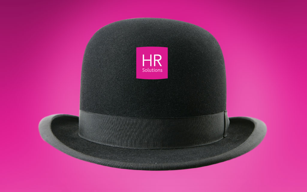 Black bowler hat on pink background