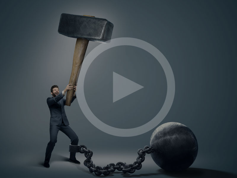 Man holding giant hammer with weight chained to his leg